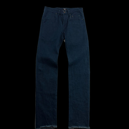 A pair of dark blue denim jeans laid flat on a white surface, showing the front pockets, waistband, and frayed hems.