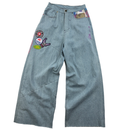 Blue jeans with patches on a white background